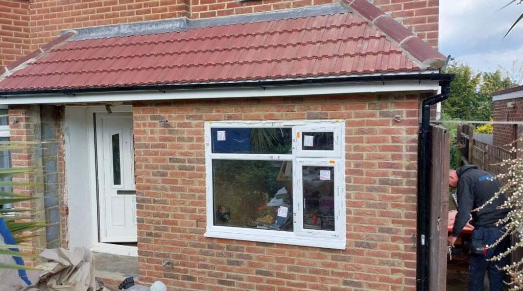 Exterior brickwork and window installation on residential property